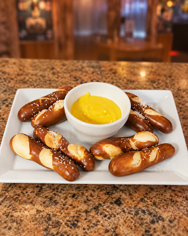 Pretzel sticks with cheese sauce