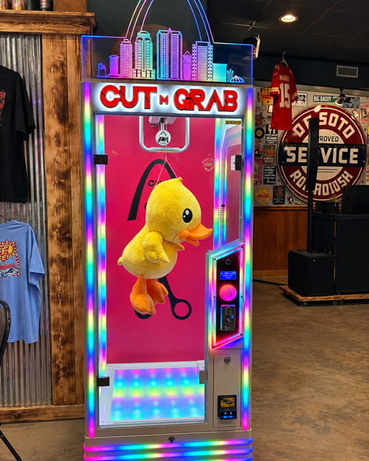 Cut N Grab machine with a giant yellow duck plush