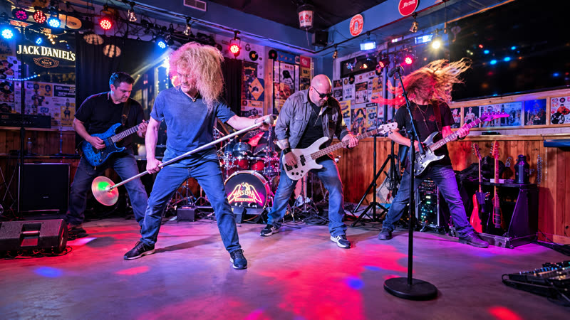 A live band on stage under neon lights at Double D's Roadhouse